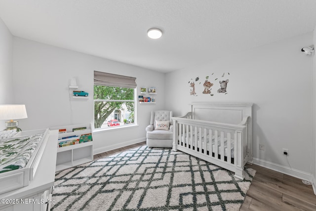 6547 Burnham Cir, Ponte Vedra Beach, FL 32082 - bedroom with wood finished floors, baseboards, and a crib