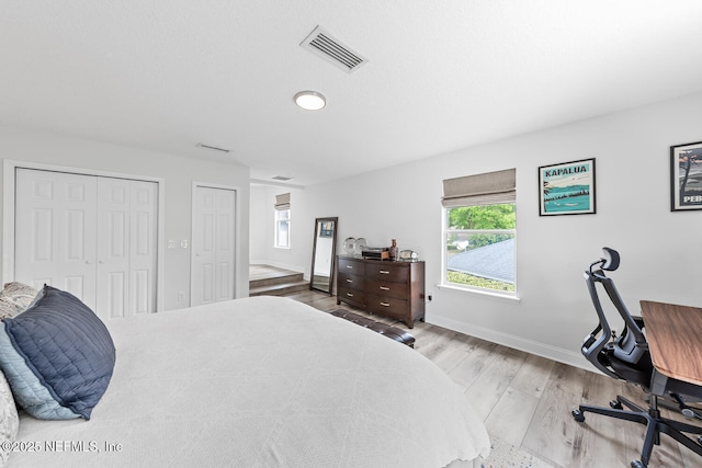 6547 Burnham Cir, Ponte Vedra Beach, FL 32082 - bedroom with two closets, wood finished floors, a desk, and baseboards