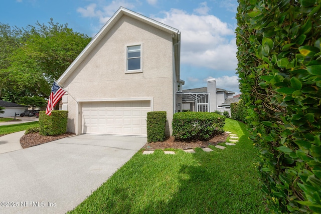 6547 Burnham Cir, Ponte Vedra Beach, FL 32082 - view of side of property with an attached garage, stucco siding, driveway, and a yard