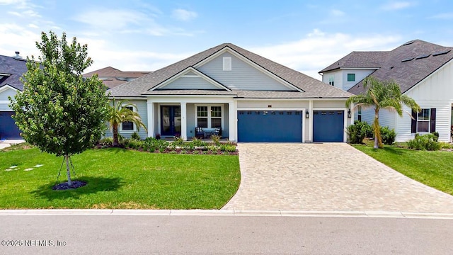 638 Windley Dr, Saint Augustine, FL 32092 - view of front facade with an attached garage, a front yard, decorative driveway, and a shingled roof