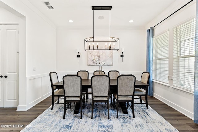 638 Windley Dr, Saint Augustine, FL 32092 - dining space featuring a chandelier, dark wood-style flooring, ornamental molding, and wainscoting