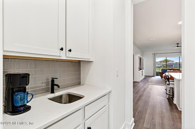 638 Windley Dr, Saint Augustine, FL 32092 - bar area featuring a sink, decorative backsplash, wood finished floors, and baseboards