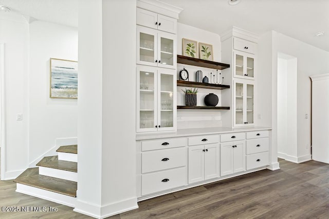 638 Windley Dr, Saint Augustine, FL 32092 - bar with dark wood-style flooring, baseboards, and stairs