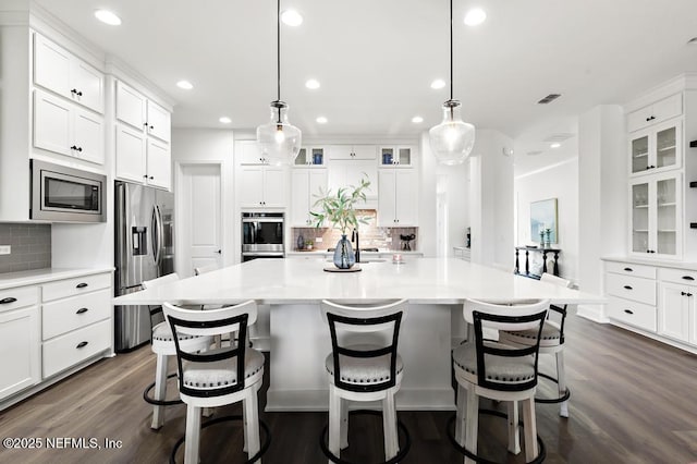 638 Windley Dr, Saint Augustine, FL 32092 - kitchen featuring stainless steel appliances, decorative backsplash, recessed lighting, dark wood-type flooring, and white cabinets
