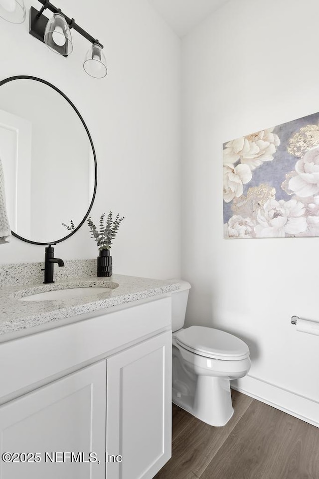638 Windley Dr, Saint Augustine, FL 32092 - half bath featuring vanity, toilet, and wood finished floors