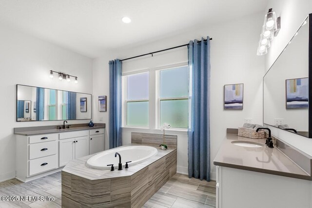 638 Windley Dr, Saint Augustine, FL 32092 - full bath with a garden tub, two vanities, baseboards, and recessed lighting
