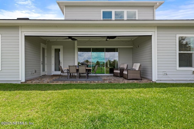638 Windley Dr, Saint Augustine, FL 32092 - rear view of house with ceiling fan, a patio area, a yard, and outdoor lounge area
