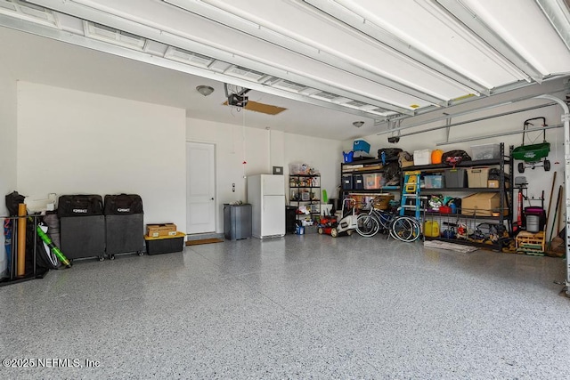 638 Windley Dr, Saint Augustine, FL 32092 - garage with freestanding refrigerator and a garage door opener