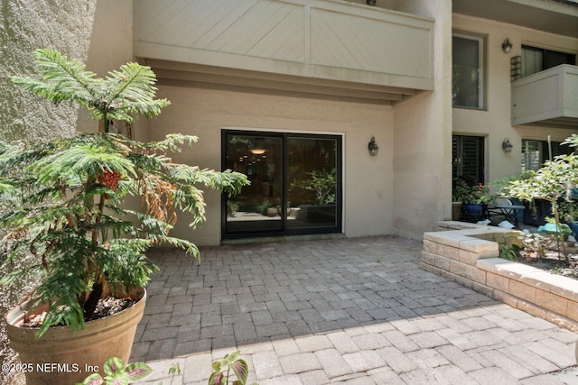3036 Sea Marsh Rd, Fernandina Beach, FL 32034 - view of exterior entry featuring stucco siding and a patio