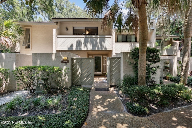 3036 Sea Marsh Rd, Fernandina Beach, FL 32034 - view of front of home with a balcony, stucco siding, and a gate