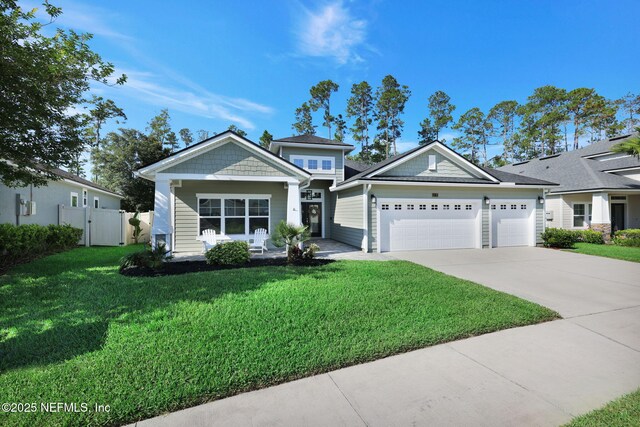 25 Carnauba Way, Jacksonville, FL 32081 - view of front of property with a garage, concrete driveway, and a porch