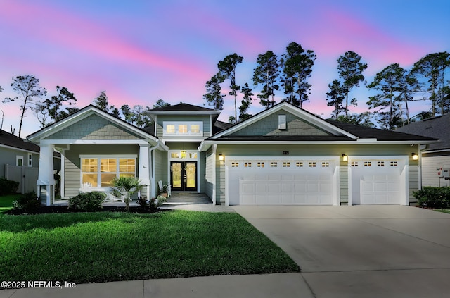 25 Carnauba Way, Jacksonville, FL 32081 - view of front of property with french doors, driveway, an attached garage, and a yard