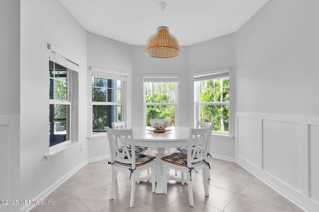 25 Carnauba Way, Jacksonville, FL 32081 - dining area with plenty of natural light, wainscoting, and light tile patterned flooring