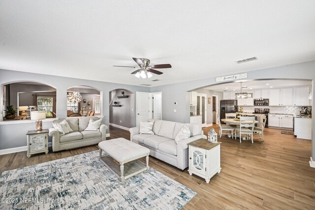 145 Thornloe Dr, Saint Johns, FL 32259 - living room with ceiling fan, light wood-style flooring, arched walkways, and baseboards