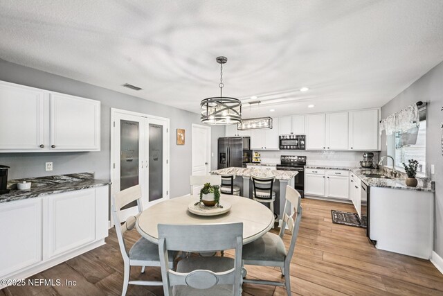 145 Thornloe Dr, Saint Johns, FL 32259 - dining room featuring recessed lighting, light wood-style floors, and a chandelier