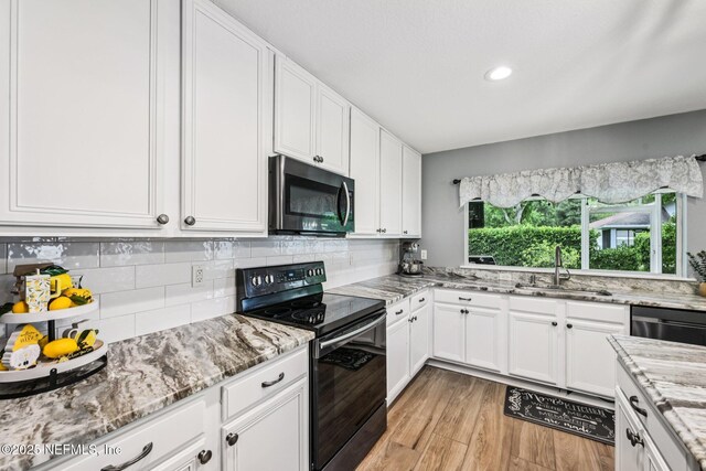 145 Thornloe Dr, Saint Johns, FL 32259 - kitchen featuring stainless steel appliances, a sink, white cabinets, light wood-style floors, and recessed lighting
