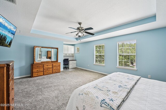 145 Thornloe Dr, Saint Johns, FL 32259 - bedroom with carpet floors, a tray ceiling, a textured ceiling, baseboards, and ceiling fan