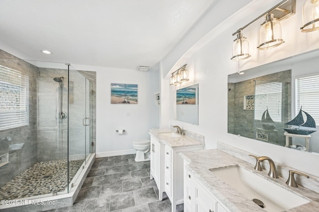 145 Thornloe Dr, Saint Johns, FL 32259 - bathroom with baseboards, a shower stall, two vanities, toilet, and stone finish floors