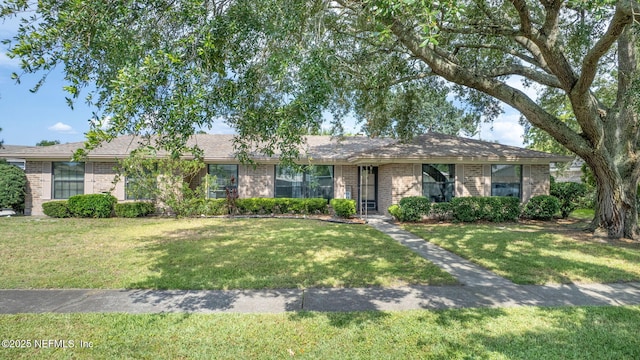 147 Quarton Dr, Orange Park, FL 32073 - ranch-style home featuring brick siding and a front lawn