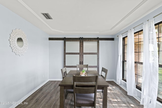 147 Quarton Dr, Orange Park, FL 32073 - dining space featuring a barn door, wood finished floors, plenty of natural light, and baseboards