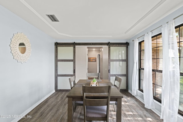 147 Quarton Dr, Orange Park, FL 32073 - dining room featuring a barn door, wood finished floors, plenty of natural light, and baseboards