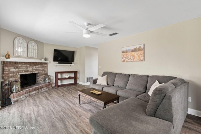 147 Quarton Dr, Orange Park, FL 32073 - living area with wood finished floors, baseboards, a ceiling fan, and a fireplace
