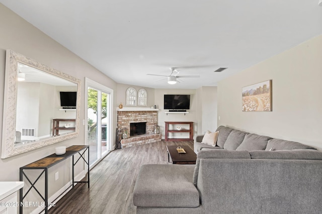147 Quarton Dr, Orange Park, FL 32073 - living area with wood finished floors, a ceiling fan, and a fireplace