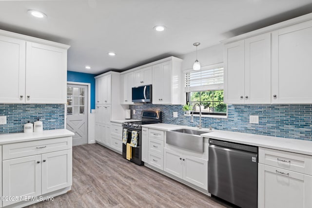 147 Quarton Dr, Orange Park, FL 32073 - kitchen featuring appliances with stainless steel finishes, a sink, backsplash, white cabinets, and light countertops