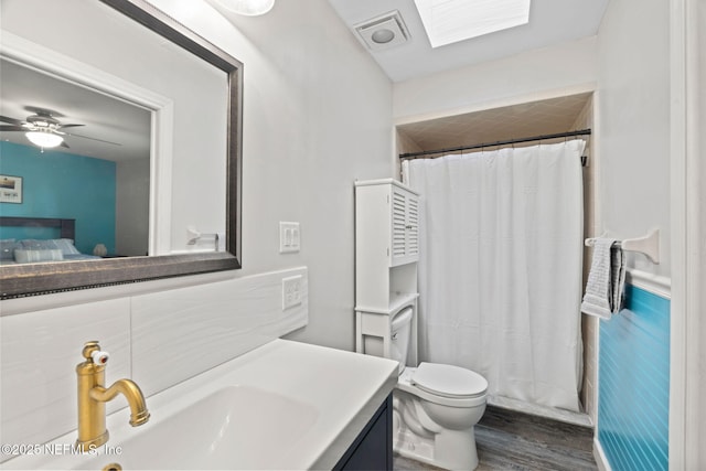 147 Quarton Dr, Orange Park, FL 32073 - bathroom featuring wood finished floors, vanity, toilet, and a shower with shower curtain