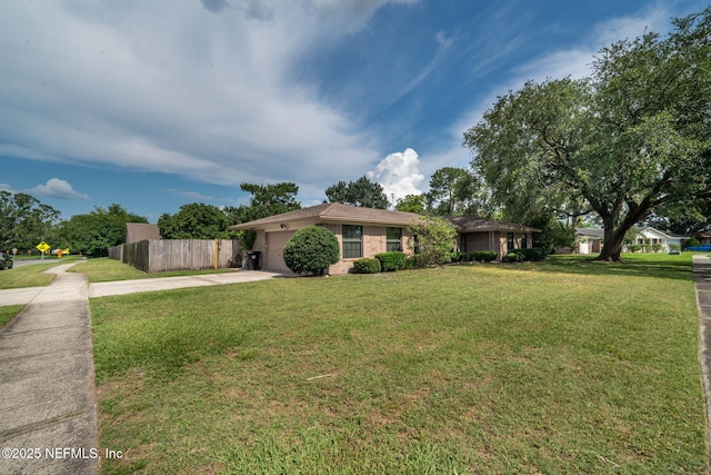 147 Quarton Dr, Orange Park, FL 32073 - ranch-style house with concrete driveway, an attached garage, and brick siding