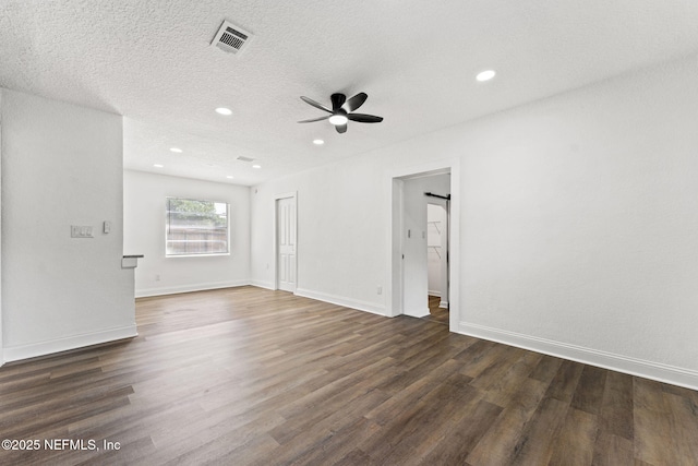 9007 7th Ave, Jacksonville, FL 32208 - empty room with a ceiling fan, dark wood-style flooring, recessed lighting, baseboards, and a textured ceiling