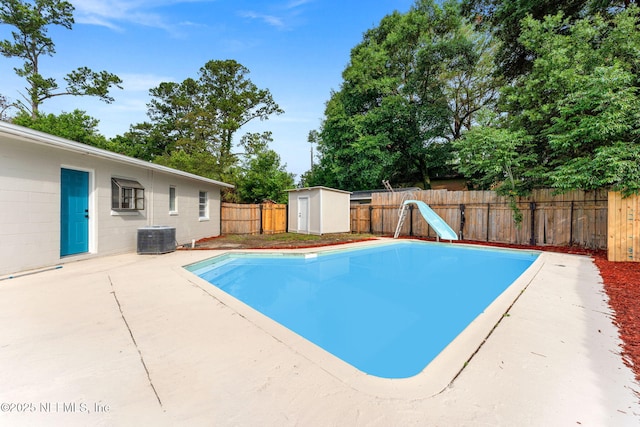 9007 7th Ave, Jacksonville, FL 32208 - view of pool featuring a water slide, a fenced backyard, a patio area, and central AC