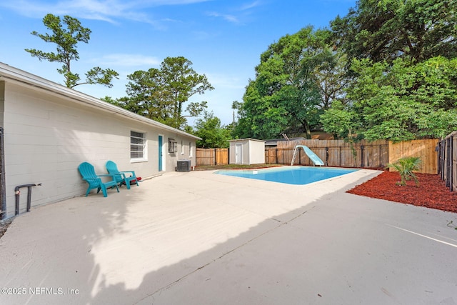 9007 7th Ave, Jacksonville, FL 32208 - view of swimming pool with a water slide, central air condition unit, a patio area, and a fenced backyard