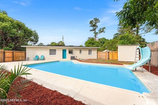9007 7th Ave, Jacksonville, FL 32208 - view of pool with a water slide, a fenced backyard, cooling unit, and a patio