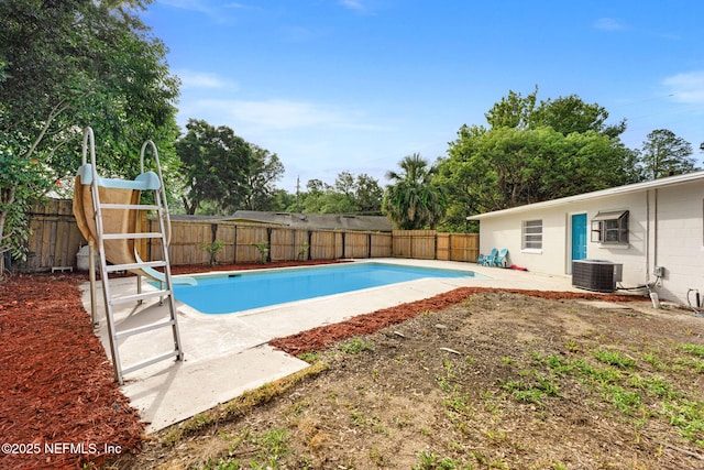 9007 7th Ave, Jacksonville, FL 32208 - view of pool with a water slide, a fenced backyard, a patio, and central AC unit