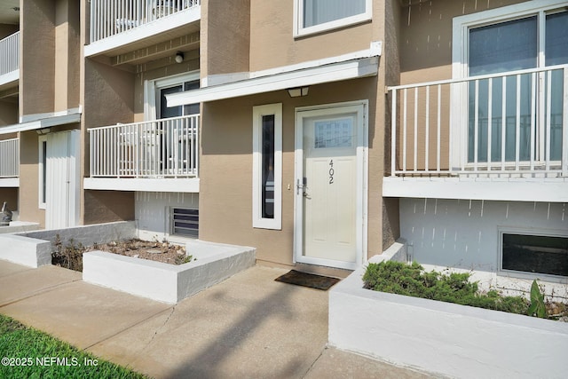 2898 Ocean Shore Blvd Unit 4020, Ormond Beach, FL 32176 - doorway to property with stucco siding