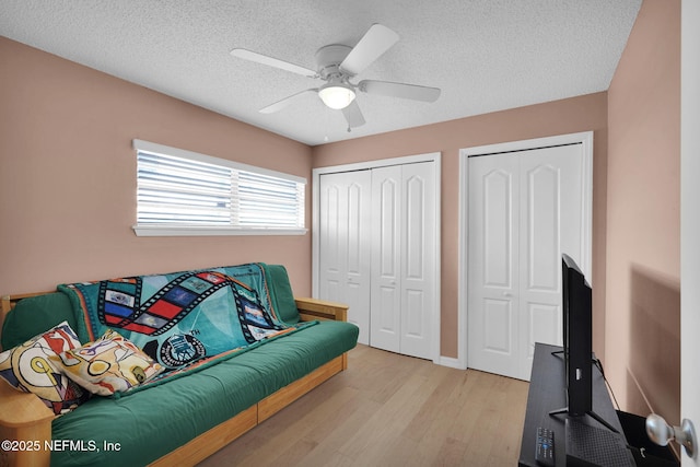 2898 Ocean Shore Blvd Unit 4020, Ormond Beach, FL 32176 - living area featuring light wood-style flooring, a ceiling fan, a textured ceiling, and baseboards