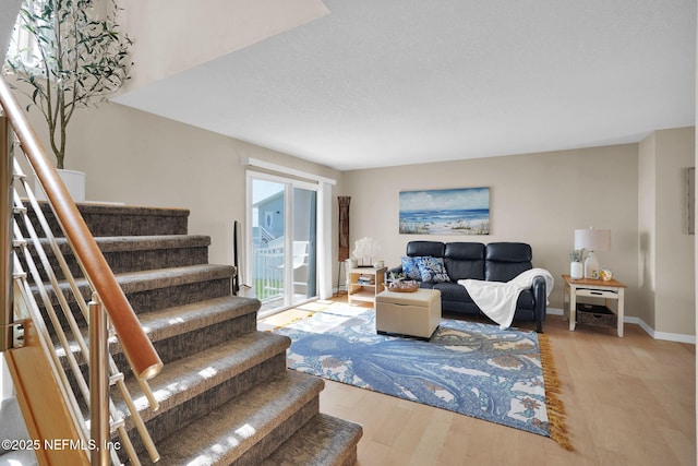 2898 Ocean Shore Blvd Unit 4020, Ormond Beach, FL 32176 - living area with stairway, wood finished floors, and baseboards