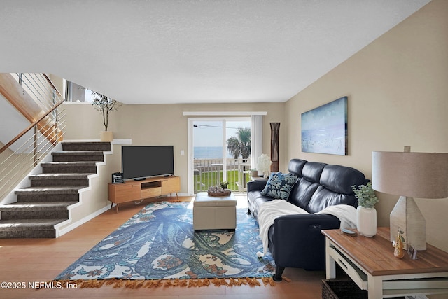 2898 Ocean Shore Blvd Unit 4020, Ormond Beach, FL 32176 - living area with stairs, wood finished floors, and baseboards