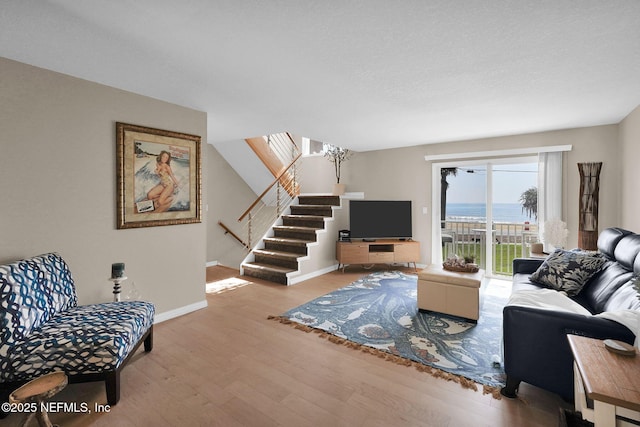 2898 Ocean Shore Blvd Unit 4020, Ormond Beach, FL 32176 - living area with wood finished floors, stairway, and baseboards