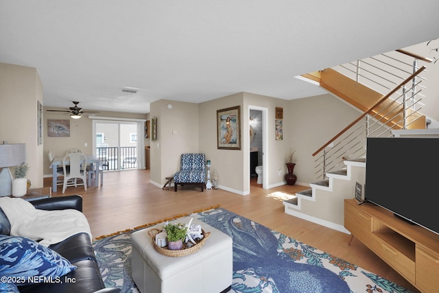 2898 Ocean Shore Blvd Unit 4020, Ormond Beach, FL 32176 - living room featuring wood finished floors, a ceiling fan, baseboards, and stairway