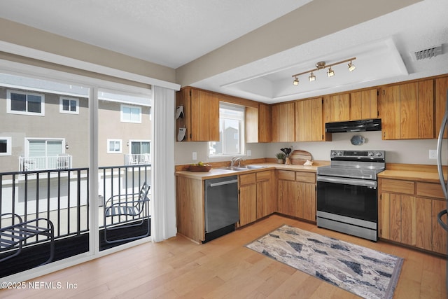 2898 Ocean Shore Blvd Unit 4020, Ormond Beach, FL 32176 - kitchen featuring stainless steel appliances, a sink, light countertops, and a tray ceiling