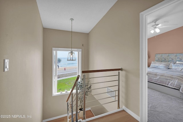 2898 Ocean Shore Blvd Unit 4020, Ormond Beach, FL 32176 - stairway featuring baseboards, ceiling fan, and lofted ceiling