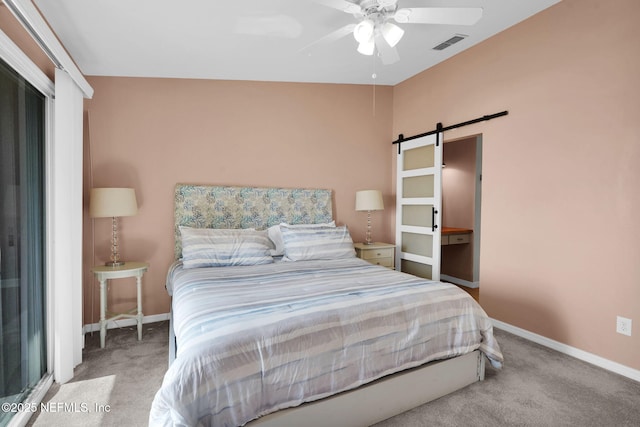 2898 Ocean Shore Blvd Unit 4020, Ormond Beach, FL 32176 - bedroom with a barn door, carpet, baseboards, and a ceiling fan