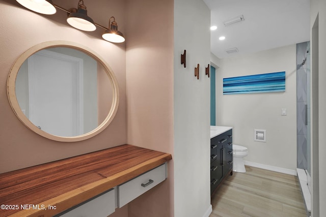 2898 Ocean Shore Blvd Unit 4020, Ormond Beach, FL 32176 - bathroom with vanity, wood finished floors, toilet, baseboards, and a shower