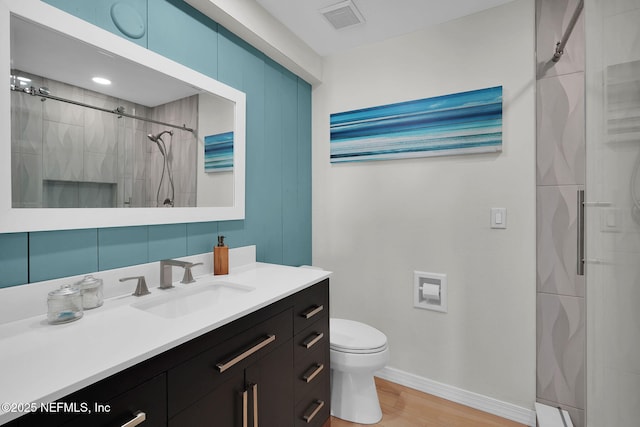 2898 Ocean Shore Blvd Unit 4020, Ormond Beach, FL 32176 - full bathroom with a shower stall, toilet, vanity, baseboards, and wood finished floors