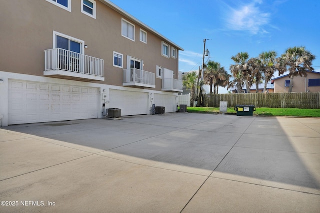 2898 Ocean Shore Blvd Unit 4020, Ormond Beach, FL 32176 - rear view of house with stucco siding, a garage, and cooling unit
