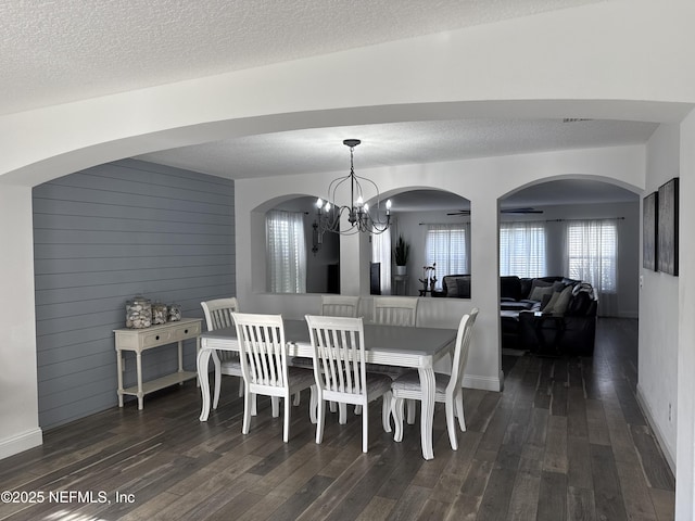 305 Carriage Hill Ct, Saint Johns, FL 32259 - dining area featuring dark wood finished floors, baseboards, a chandelier, a textured ceiling, and wooden walls