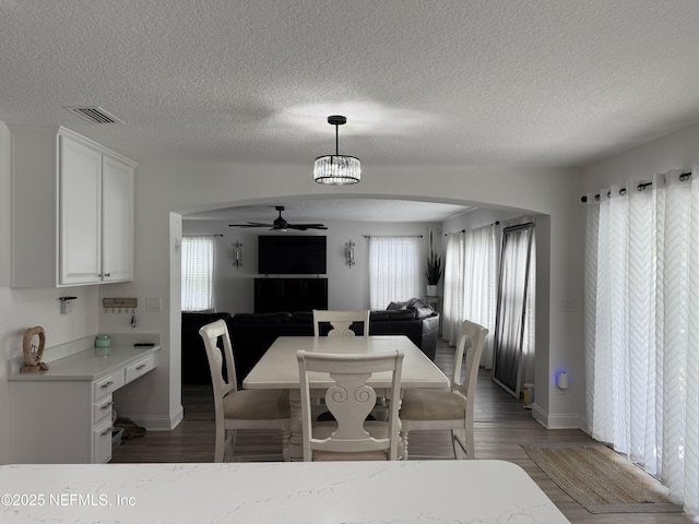 305 Carriage Hill Ct, Saint Johns, FL 32259 - dining room with ceiling fan, arched walkways, light wood finished floors, baseboards, and a textured ceiling