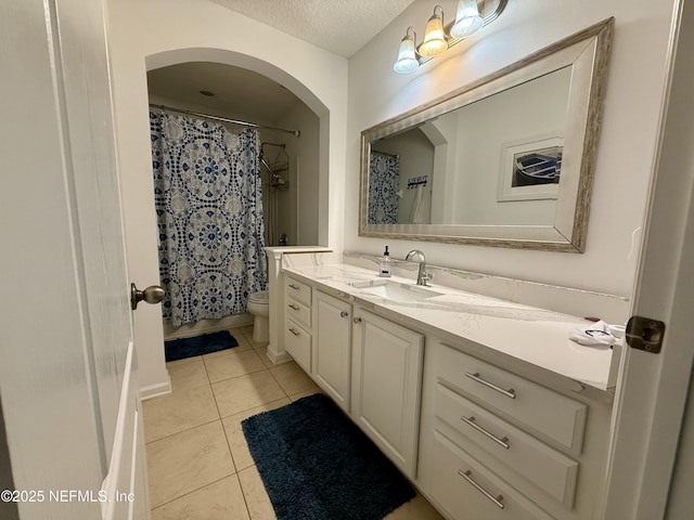 305 Carriage Hill Ct, Saint Johns, FL 32259 - bathroom with vanity, toilet, tile patterned flooring, a textured ceiling, and a shower with curtain
